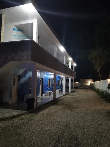 a building with a mural on the side of it at night at Blue Hotel in Bacalar