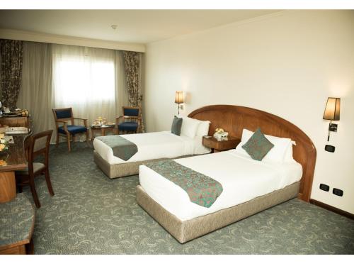 Katil atau katil-katil dalam bilik di Cherry Maryski Hotel