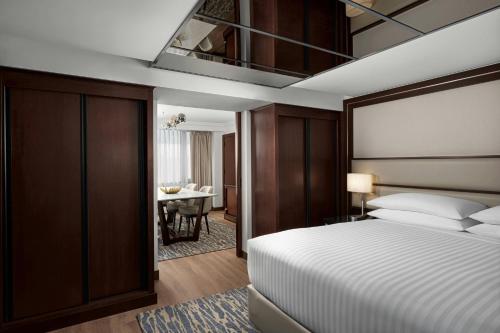 a hotel room with a bed and a desk at Amman Marriott Hotel in Amman