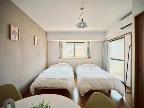 Ένα ή περισσότερα κρεβάτια σε δωμάτιο στο vetta kumamoto suizenji2 204
