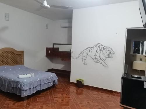 a room with a drawing of a tiger on the wall at Blue Hotel in Bacalar