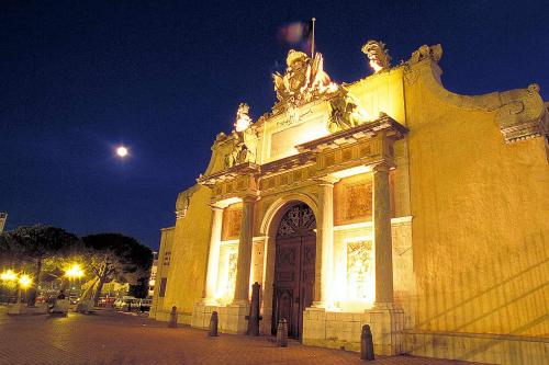 a large building with a large door at night at Ibis Budget Toulon Centre in Toulon