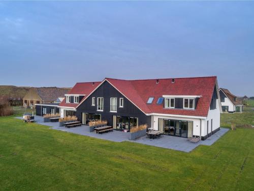 an aerial view of a large house with a yard at Modern villa in De Cocksdorp near the beach in De Cocksdorp