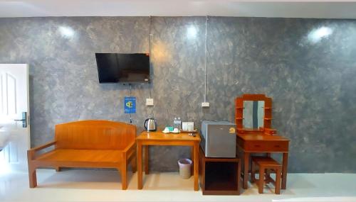 a room with a table and a chair and a mirror at J House Has Love in Sukhothai