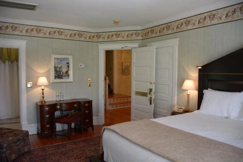 a bedroom with a bed and a table and a desk at Bluff View Inn in Chattanooga