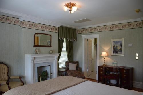 a bedroom with a bed and a fireplace at Bluff View Inn in Chattanooga