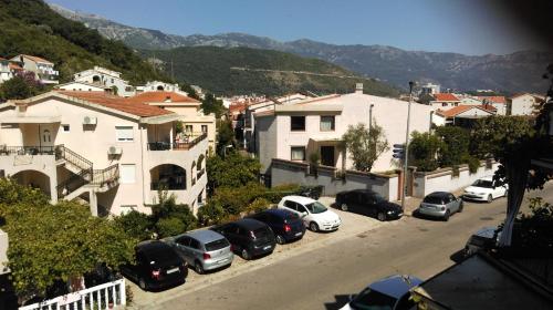 a bunch of cars parked in a parking lot at Apartman Bećir in Budva