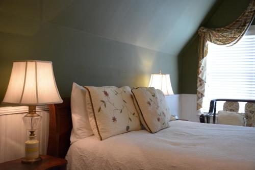 a bedroom with a bed with two lamps on it at Bluff View Inn in Chattanooga