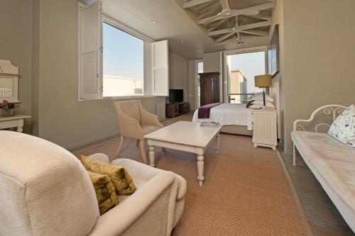 a living room with a couch and a table at Mosselberg on Grotto Beach in Hermanus