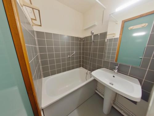 a bathroom with a sink and a bath tub at Studio lumineux avec loggia aux Rousses - FR-1-834-12 in Les Rousses