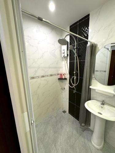 a bathroom with a shower and a sink at Buncha Place in Bang Tao Beach