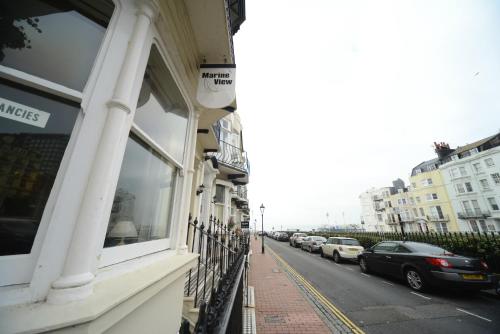 a city street with cars parked on the side of the road at Marine View in Brighton & Hove