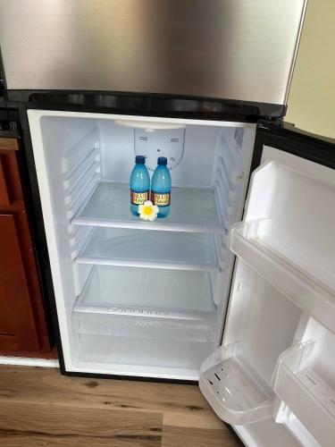 two bottles of water in an open refrigerator at Kona Nook - Cozy Studio with Island Warmth in Kailua-Kona