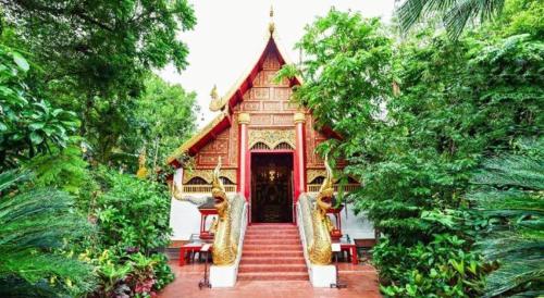 a small building with stairs leading to a doorway at Sofia Hostel in Chiang Rai
