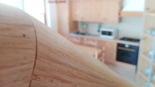 a close up of a wooden surfboard in a kitchen at Casa dei Moch in Belluno