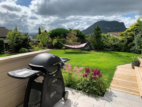 a grill sitting on the side of a garden at Cozy place near Pulpit Rock in Strand