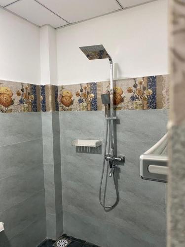 a shower in a bathroom with a shower head at Rhythm Transit Hotel - Near Airport in Katunayaka