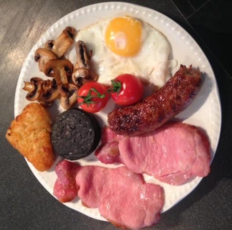 a plate of breakfast food with eggs sausage and mushrooms at The Haven in Rothbury