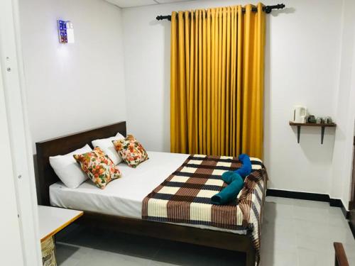 a bedroom with a bed with a blue toy on it at Rhythm Transit Hotel - Near Airport in Katunayake