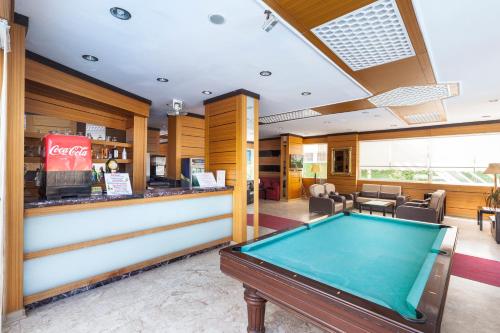 a pool table in a restaurant with a bar at Galaxy Beach Hotel Alanya in Mahmutlar