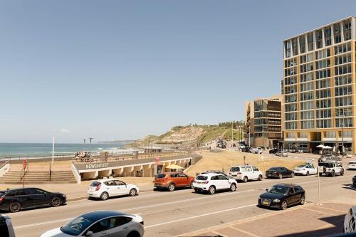 ニューカッスルにあるBeachfront Getaway with Views, Pool & Tennis Courtの浜辺に車を停めた高速道路
