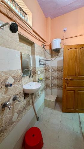 a bathroom with a sink and a toilet in it at Tandon Lodge On The Ganga Ghat Homestay in Varanasi