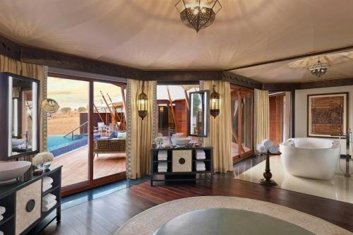 a bathroom with a tub and a large window at The Ritz-Carlton Ras Al Khaimah, Al Wadi Desert in Ras al Khaimah