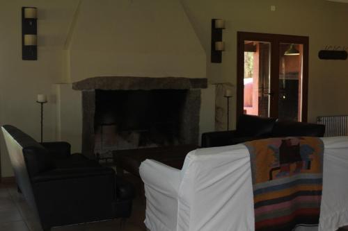a living room with a couch and a fireplace at Quinta El Monte in Tandil