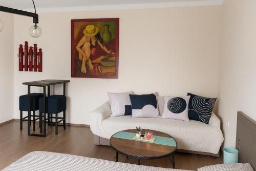 a living room with a couch and a table at Obilic L - City View apartment in Pedestrian Zone in Belgrade