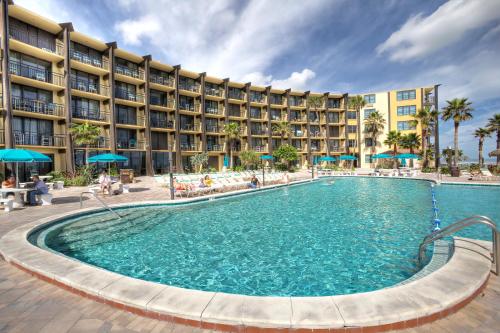a large swimming pool in front of a hotel at Daytona Beach Hawaiian Inn in Daytona Beach