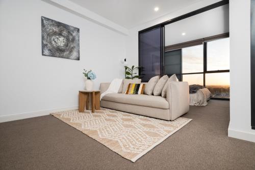 a living room with a couch and a rug at Comfort city view apartment Central Adelaide in Adelaide