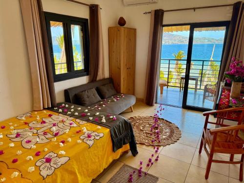 a bedroom with a bed and a view of the ocean at LE CHISSIOUA in Sada
