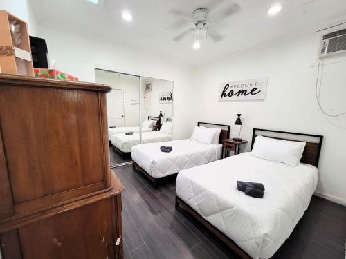 a bedroom with two beds and a dresser in it at Two bedroom private guesthouse in great location Close to Melrose Hollywood sign and attractions in Los Angeles
