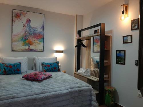 a bedroom with a bed and a large mirror at Ioni Home in Tsagarada