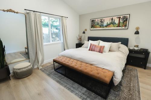 a bedroom with a large bed with a bench at Tranquil Mountain Retreat in Santa Cruz in Santa Cruz