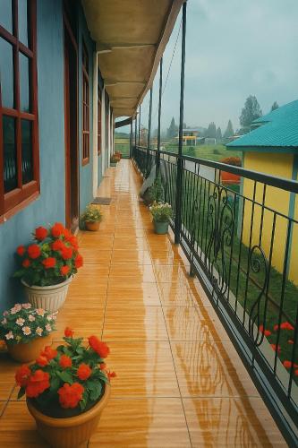 a balcony with potted plants on the side of a building at Penginapan The Guardians in Silangit International Airport