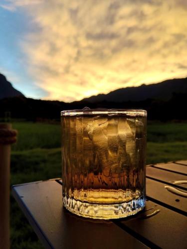 a glass of water sitting on top of a table at The Rice Chiang Dao in Ban Thung Lakhon