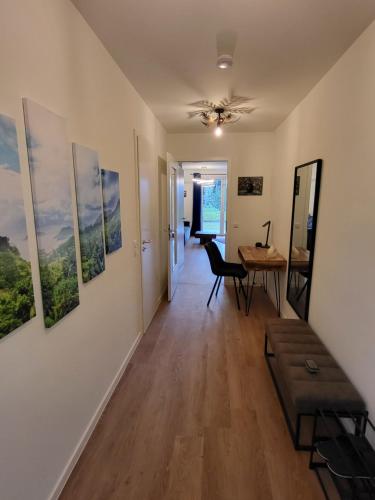 a living room with a table and paintings on the wall at Lust auf Meer in Garz