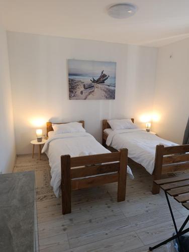 two beds in a room with two tables and two lamps at Luxury suites Marušić sobe 