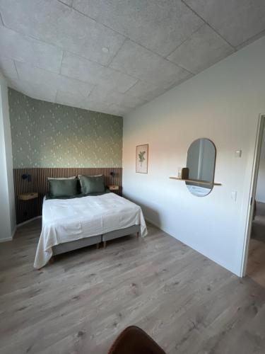 a bedroom with a white bed and a mirror at Beauty sleep Guldager in Esbjerg