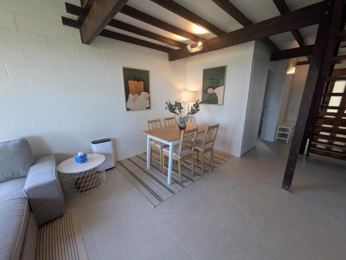 a living room with a table and a couch at Maleny-Montville Cottages #4 - 2 bed with ocean view in Maleny