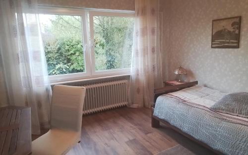 a bedroom with a bed and a large window at Gemütliche Unterkunft in Rodgau