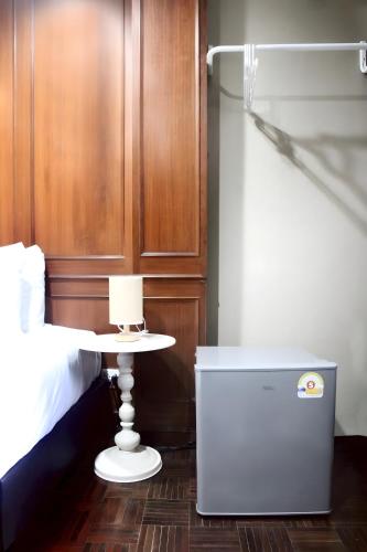 a bedroom with a bed and a nightstand next to a table at Stay On Sukhumvit 11 BTS Nana Pro in Bangkok