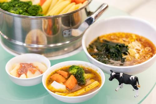 a table with bowls of food and a pot of food at Hotel Keihan Sapporo in Sapporo