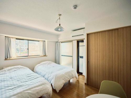 Ένα ή περισσότερα κρεβάτια σε δωμάτιο στο vetta kumamoto suizenji2 204