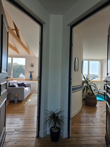 a living room with a sliding glass door at Anatoline - Appart'hotel vue mer - Sea View Apartments - Audierne in Audierne