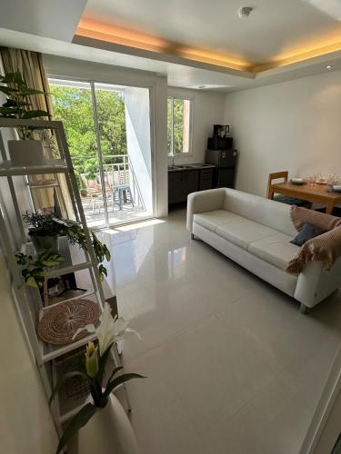 a living room with a white couch and a table at Ao Nang Pool Condo in Ao Nang Beach