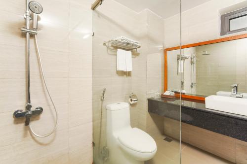 a bathroom with a toilet and a sink and a shower at GOLDEN SUN DANANG Hotel in Da Nang