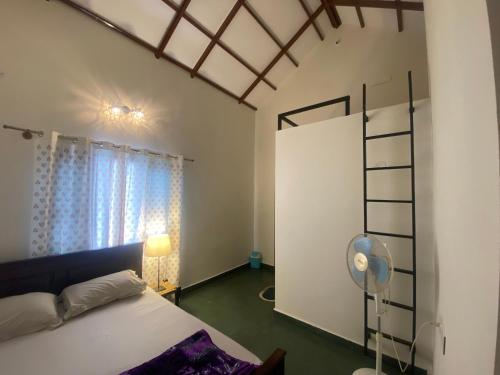 Postel nebo postele na pokoji v ubytování Sri Ranga Nilaya