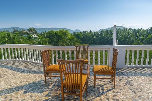a group of chairs sitting on a porch at Shraddha saburi homestay in Kashid